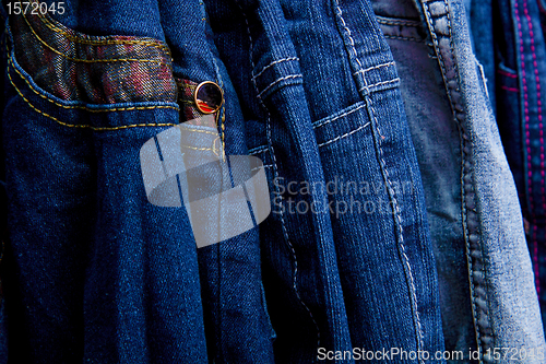 Image of Denim pants on a hanger for children in the store