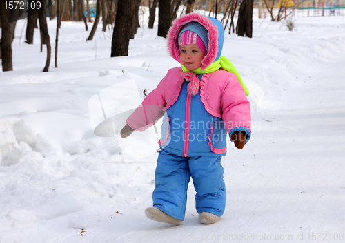 Image of baby girl walking in winter park