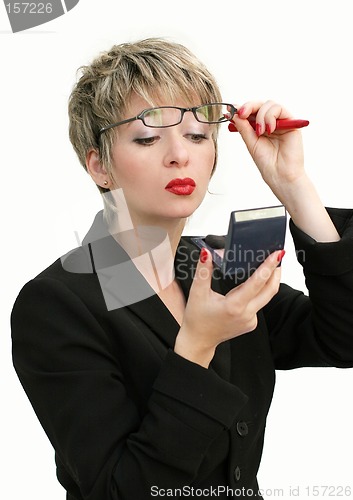 Image of Businesswoman checking her makeup