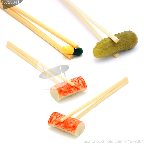Image of sushi cucumber and  tablet on chopstick