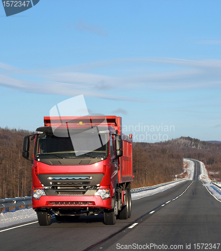 Image of The red truck on a winter road.