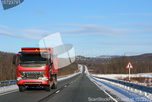 Image of The red truck on a winter road.