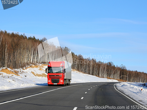 Image of The red truck on a winter road.