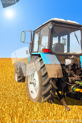 Image of Tractor in a field, agricultural scene in summer