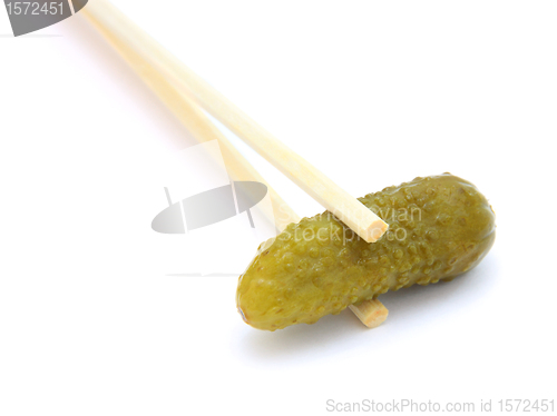 Image of sushi cucumber gherkin on chopstick