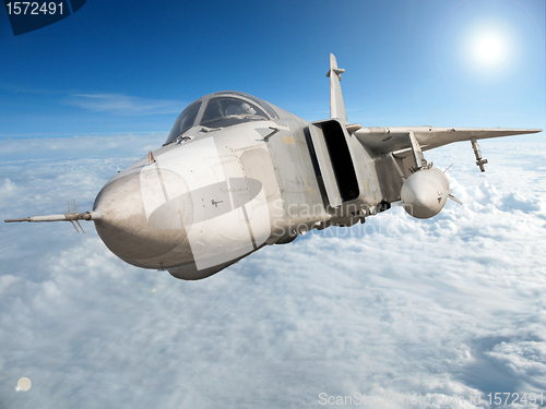 Image of Military jet bomber Su-24 Fencer flying above the clouds.