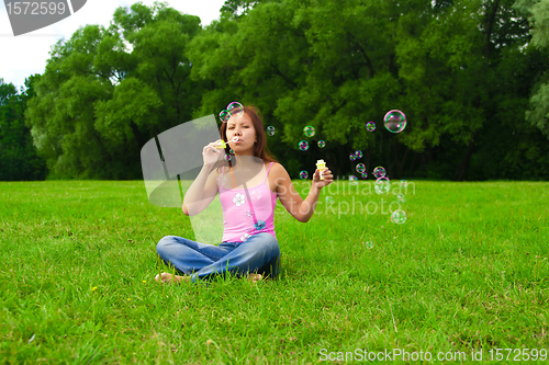 Image of girl blowing soap bubbles