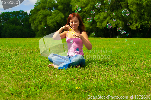 Image of girl blowing soap bubbles