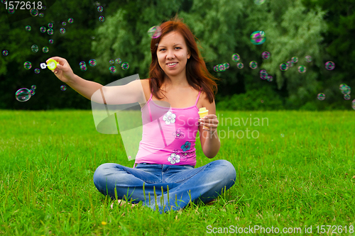 Image of girl blowing soap bubbles