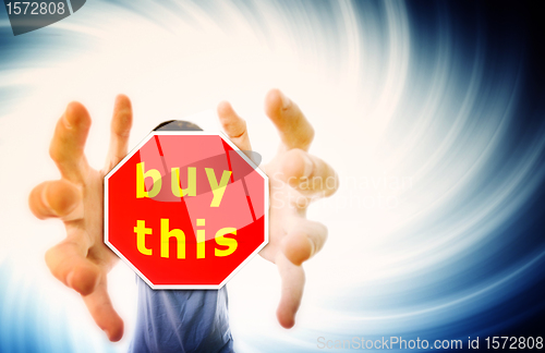 Image of Man grabing a red sign.