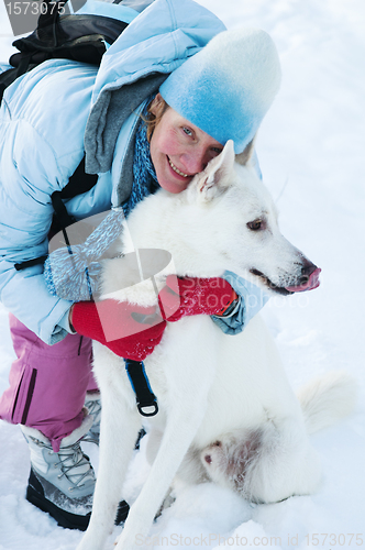 Image of The woman with a dog in winter on walk