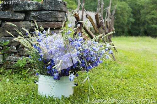 Image of bouquet of field flowers amidst the rural landscape