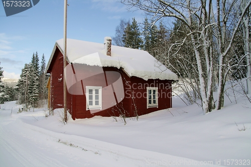 Image of Red cottage in snow