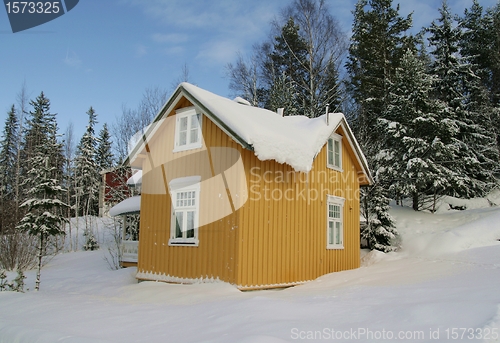 Image of Yellow house in snow