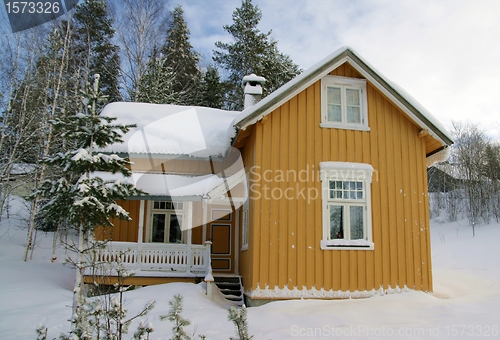 Image of Yellow house in snow