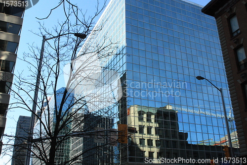 Image of Tower crane reflected on a building on Queen St. 