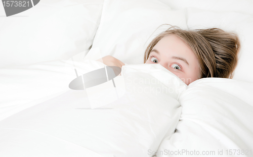 Image of young woman peeking out