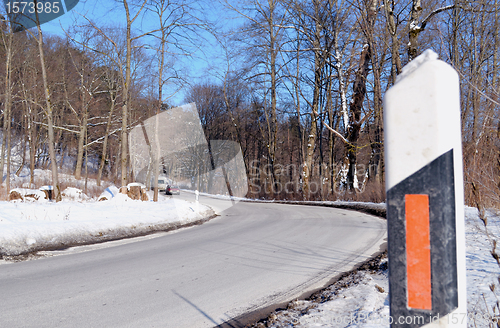 Image of Road curve mark column reflector in snowy winter 