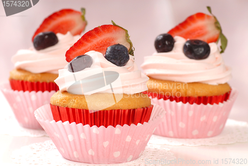 Image of Vanilla cupcakes with stawberry frosting and strawberries and bl