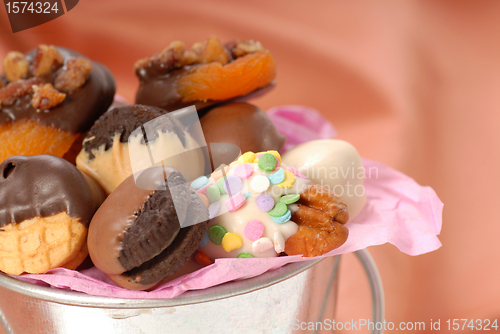 Image of Silver bucket holding a variety of chocolate covered candies and