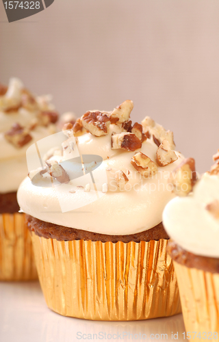 Image of Delicious carrot cake cupcake with cream cheese frosting and nut