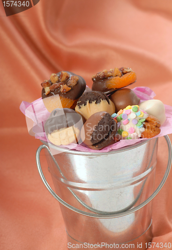 Image of Silver bucket holding a variety of chocolate covered candies and