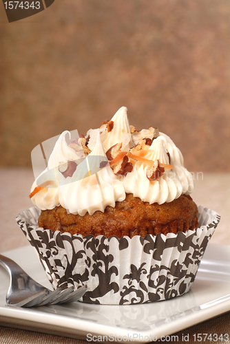 Image of Delicious carrot cake cupcake with cream cheese frosting and nut