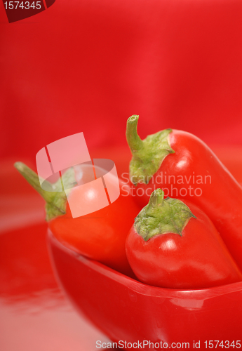 Image of Red chili peppers in a red bowl