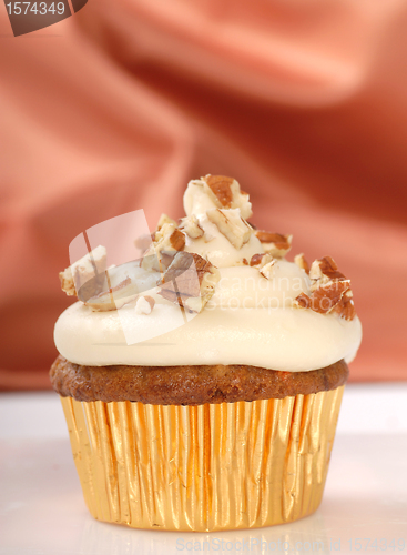 Image of Delicious carrot cake cupcake with cream cheese frosting and nut