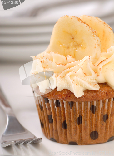 Image of Delicious carrot cake cupcake with cream cheese frosting, sliced