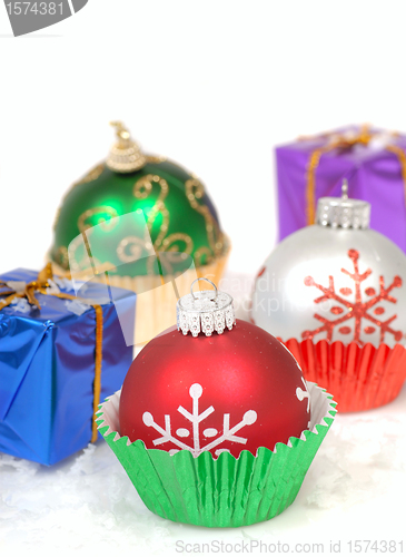 Image of Christmas ornaments in cupcake liners with gifts