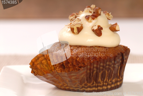 Image of Delicious carrot cake cupcake with cream cheese frosting and nut