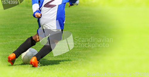 Image of Soccer player legs dribbling in a match 