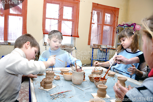 Image of children shaping clay in pottery studio