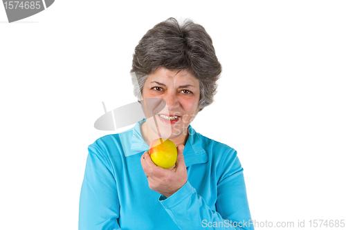 Image of Senior woman eating apple