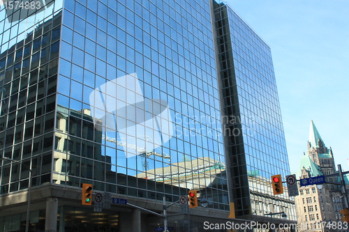 Image of Tower crane and clear sky reflected on a building, Queen St. 