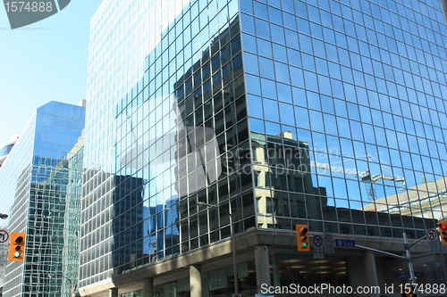 Image of Tower crane reflected on a building with light green glass, Queen St. 