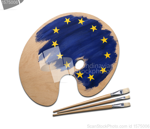 Image of wooden artists palette loaded with european flag paints and brus