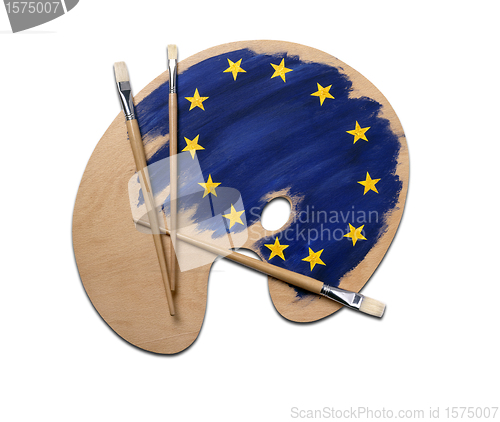 Image of wooden artists palette loaded with european flag paints and brus