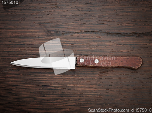 Image of Knife on rustic kitchen table 