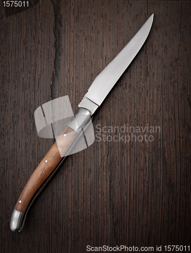 Image of Knife on wooden background