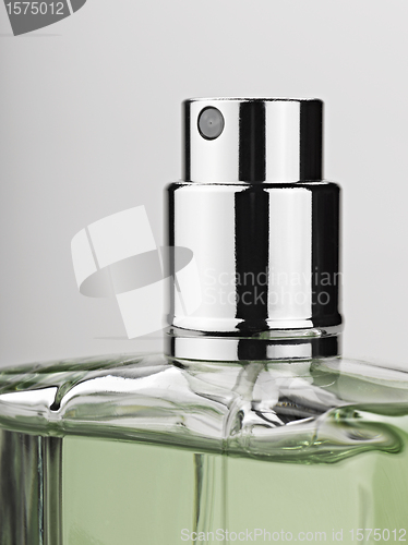 Image of bottle spray perfume against gray background