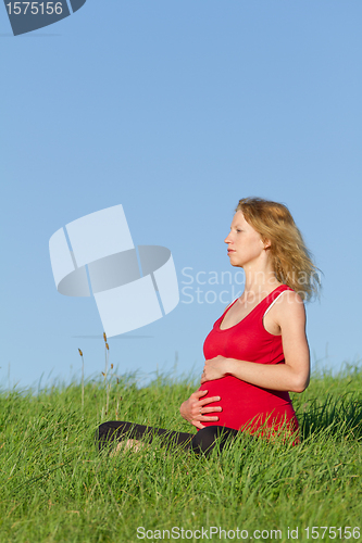 Image of pregnant woman on meadow