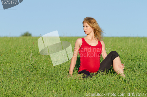 Image of pregnant woman on meadow