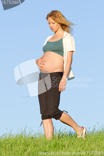 Image of pregnant woman on meadow