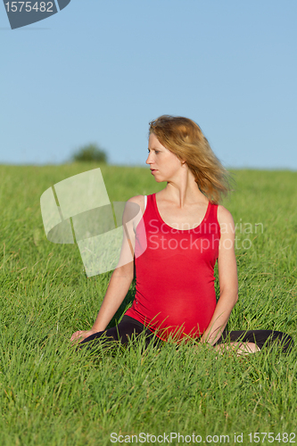 Image of pregnant woman on meadow