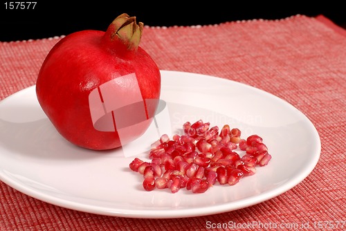 Image of Pomegranate and seeds on white plate