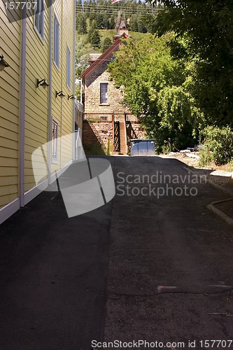 Image of Yellow Sidings of a Building in an Alley