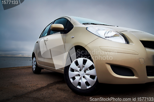 Image of Front-side closeup of a beige car