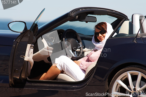 Image of Young lady sitting in cabriolet